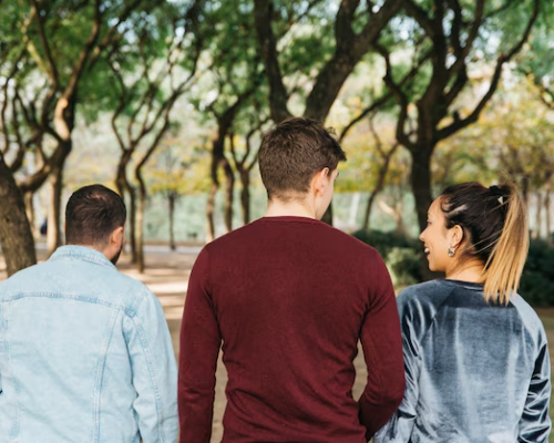 Multiethnic smiling friends walking in park and have fun